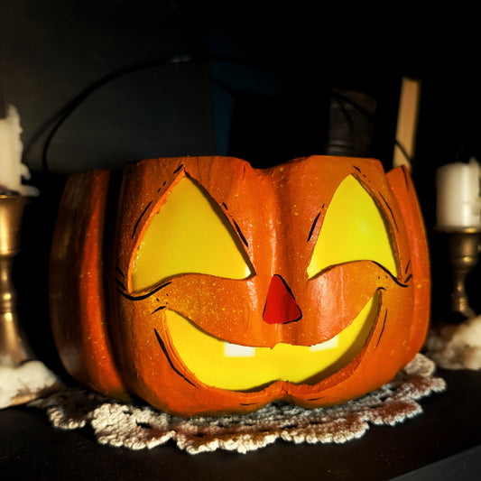 Carved Halloween pumpkin with a smiling face on a dark background